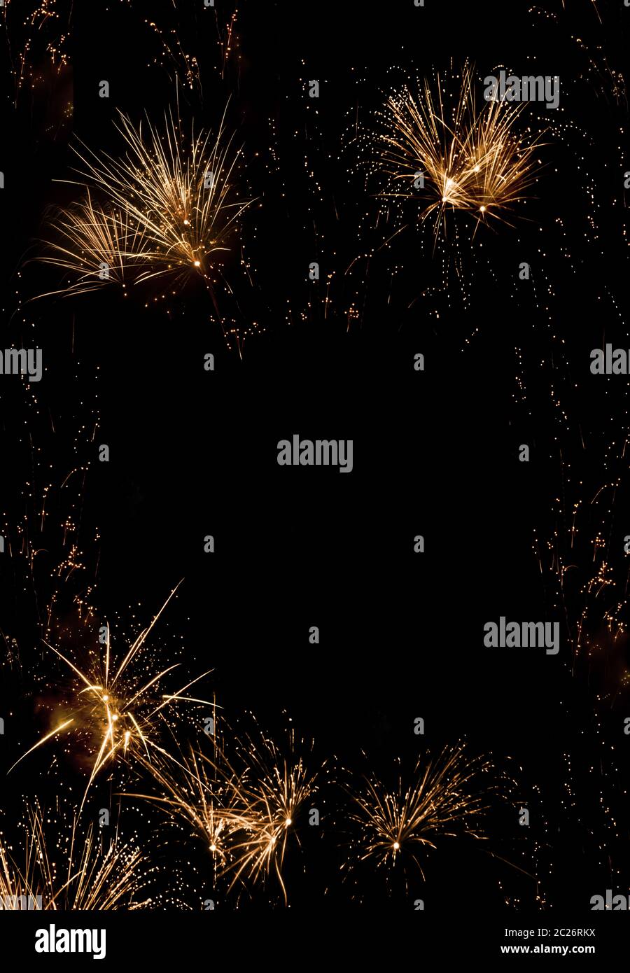 Vertical background with golden fireworks on night sky at the turn of the year Stock Photo