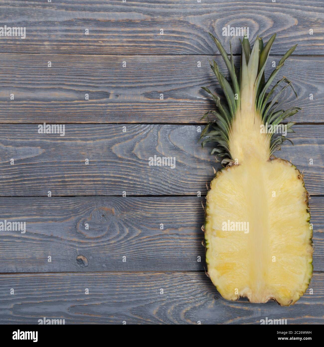 Flat lay of pineapple cut in half. White wooden table. Top view, overhead Stock Photo