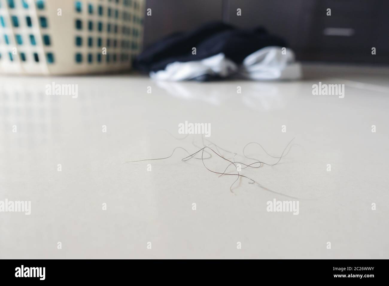 pubic hair fall on bedroom floor Stock Photo