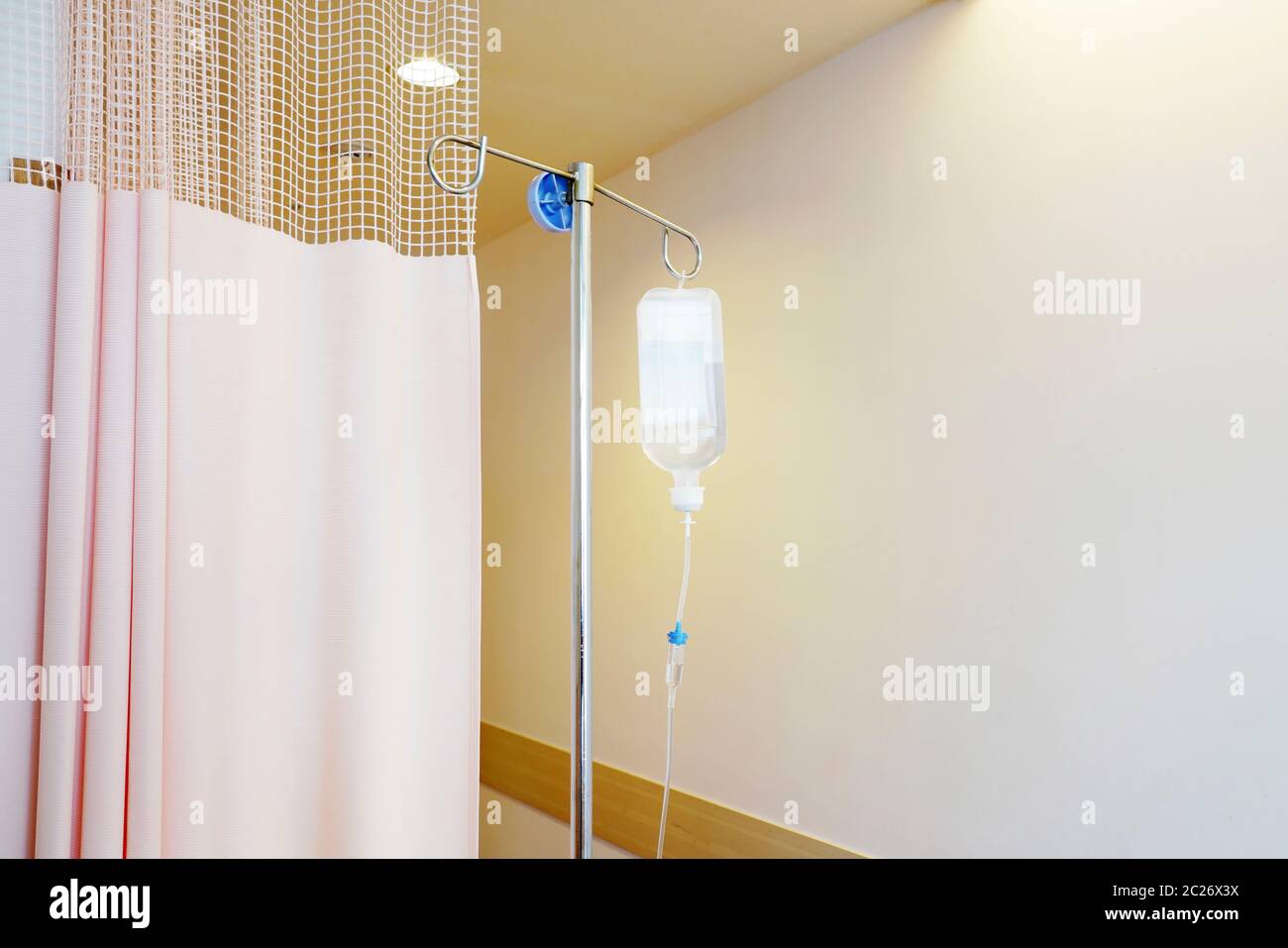 Infusion IV drip saline solution bottle medical in patient room Stock Photo