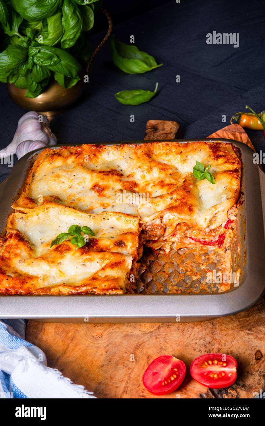 rustic spicy lasagne with basil on the tin Stock Photo Alamy