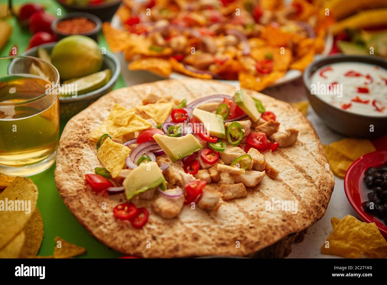 An overhead photo of an assortment of many different Mexican foods on a table Stock Photo