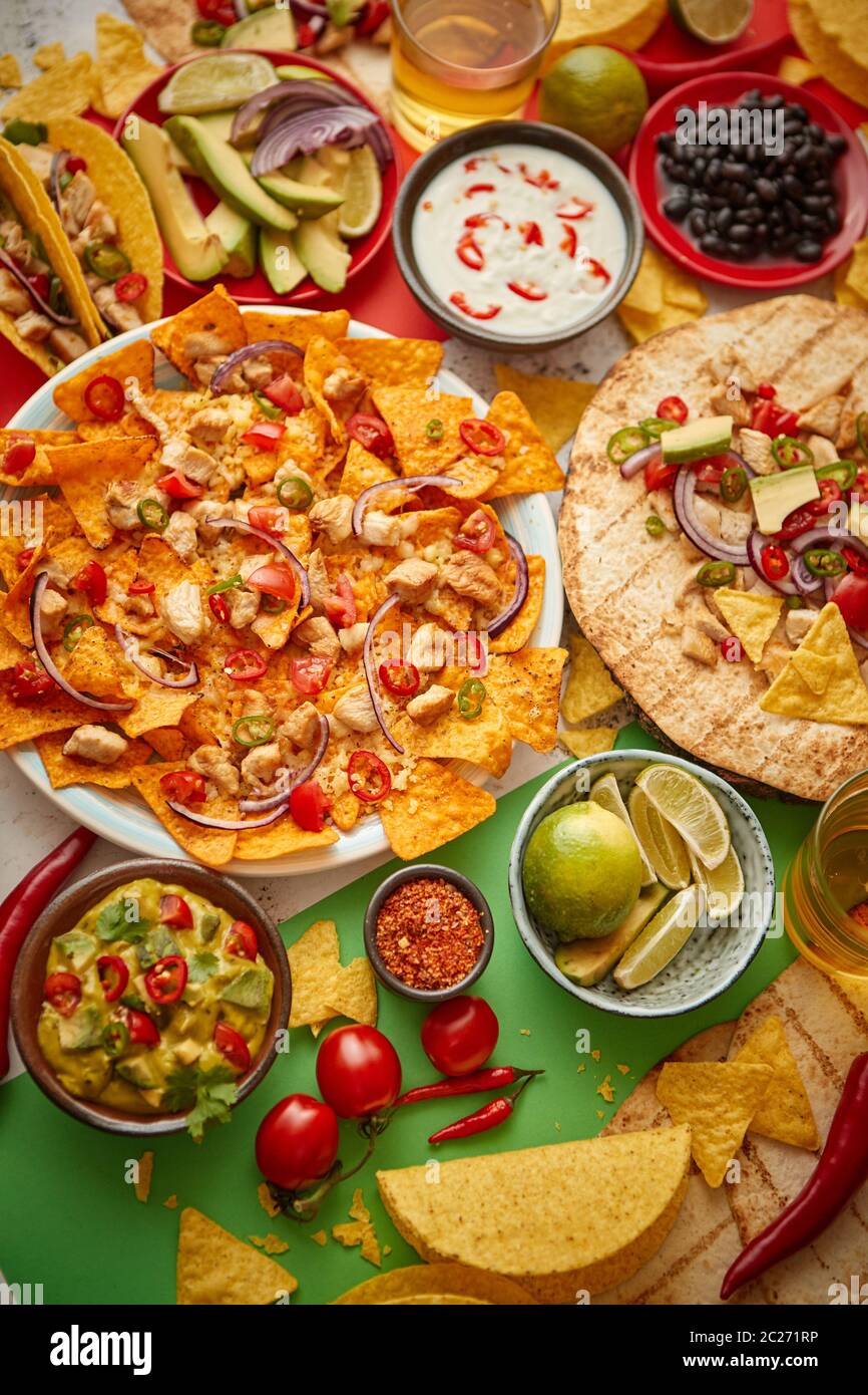 An overhead photo of an assortment of many different Mexican foods on a table Stock Photo