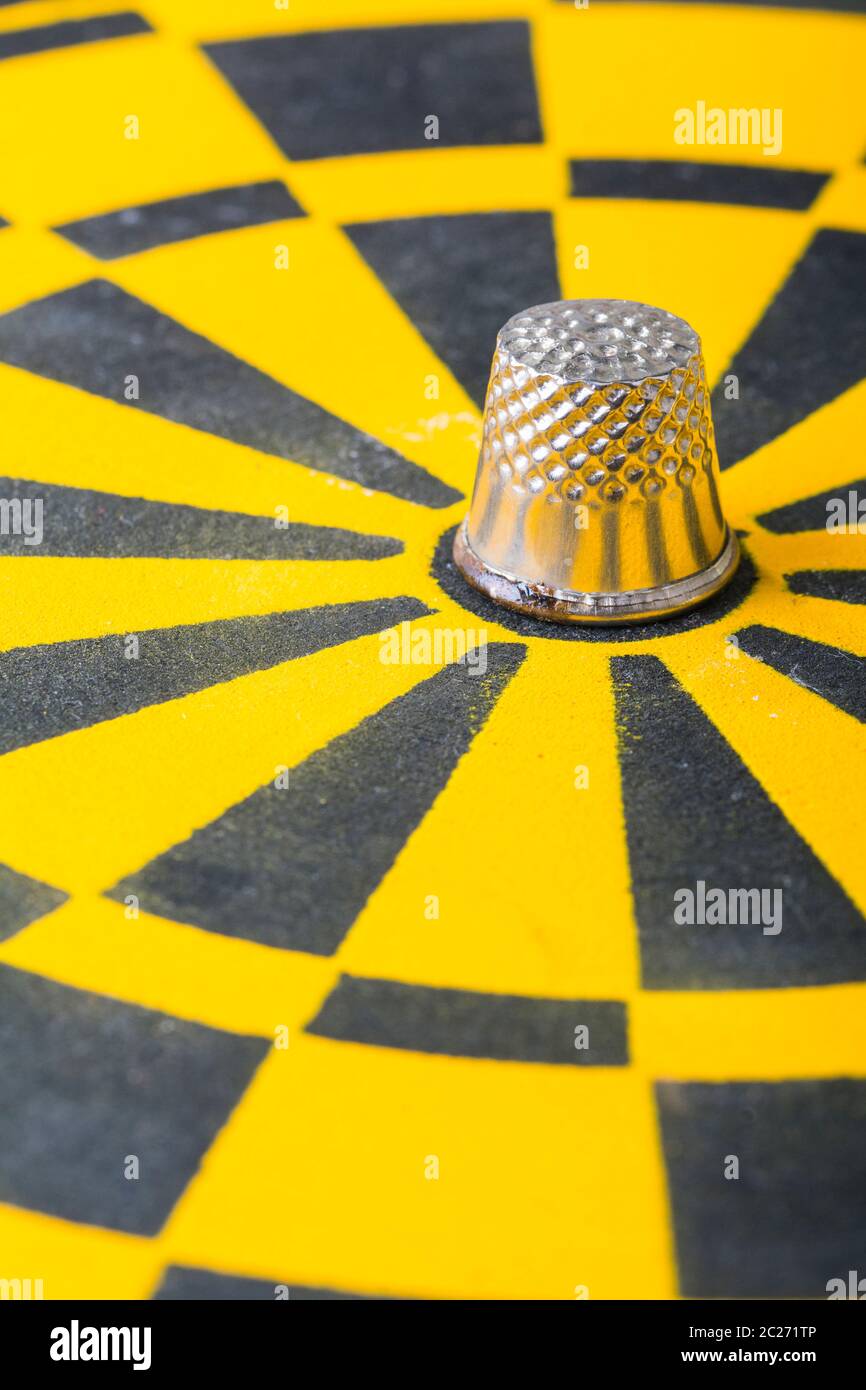 a thimble on an dartboard - symbol foto Stock Photo