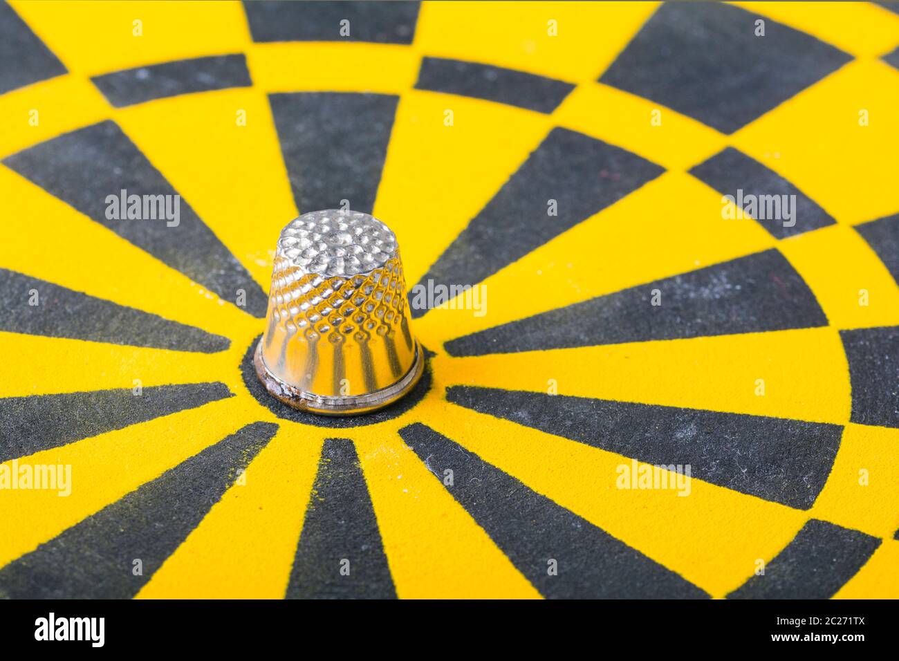 a thimble on an dartboard - symbol foto Stock Photo