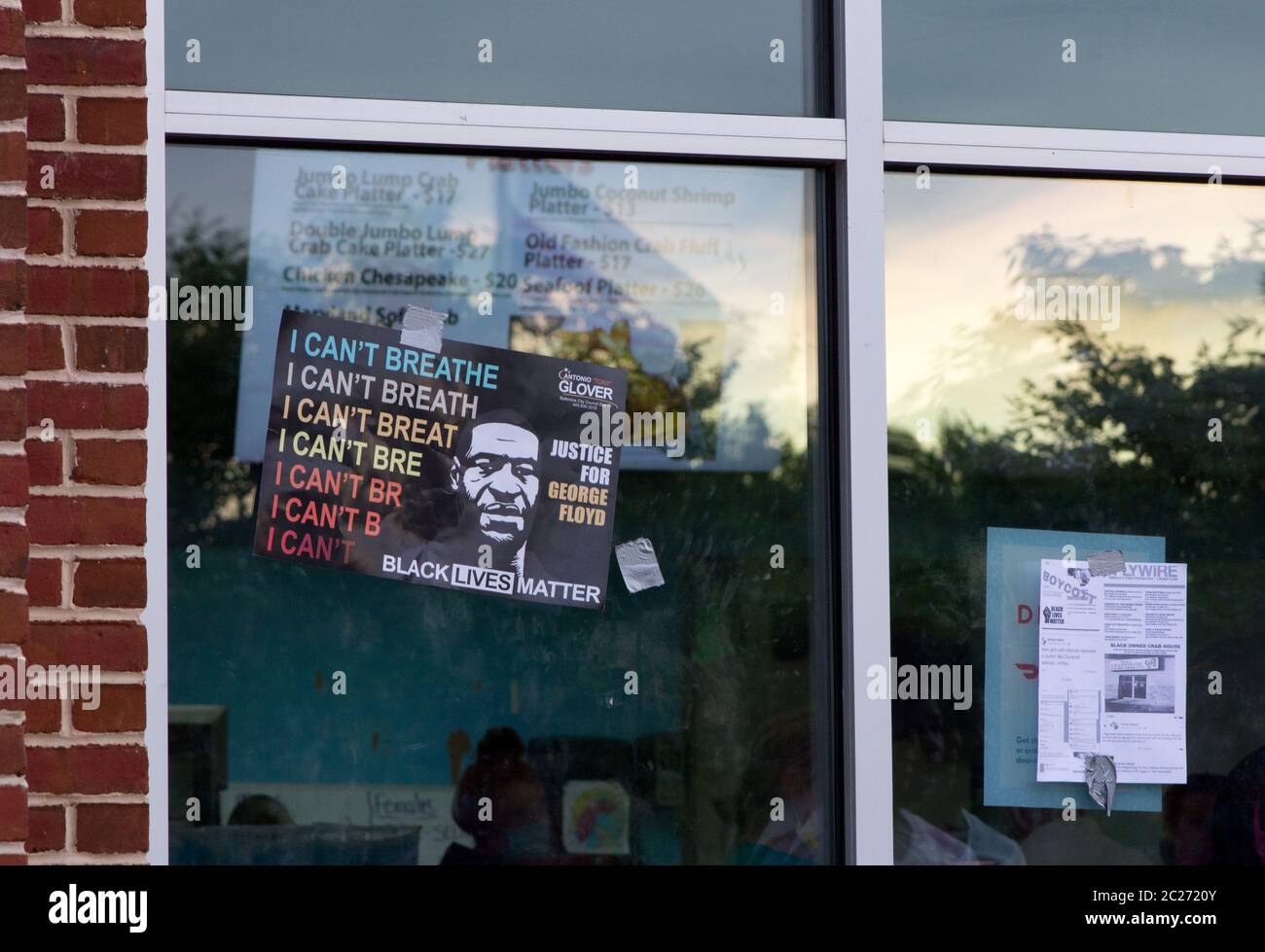 Middle River, Maryland, USA. 15th June, 2020. Antonio 'Tony' Glover Baltimore City Council District 13 Democratic Candidate Black Lives Matter Justice For George Floyd 'I Can't Breathe' placard taped on front window by a protester at the Middle River, Maryland, location of Vince's Crabhouse (Crab House), during a boycott and protest of the five-restaurant/seafood market chain over racially charged comments owner Vince Meyer made on the internet. A flyer of black-owned crab houses and Meyer's social media screenshots is below, the restaurant's menu visible through the window. Kay Howell/Alamy Stock Photo