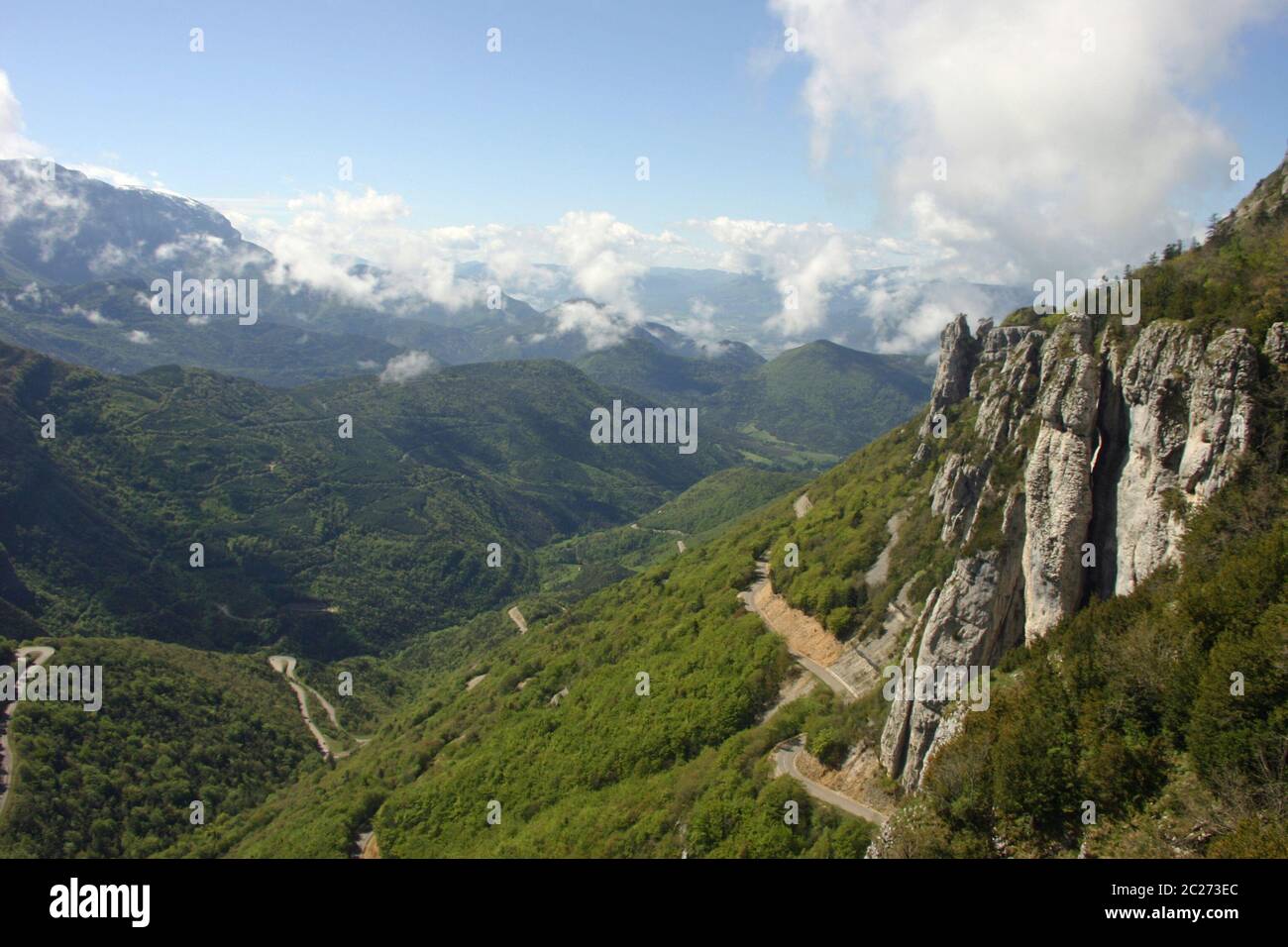 French lower alpine valley with winding roads near the Col de Rousset, part of the Vercors Regional Natural Park in the Drome valley, France.  Backgro Stock Photo