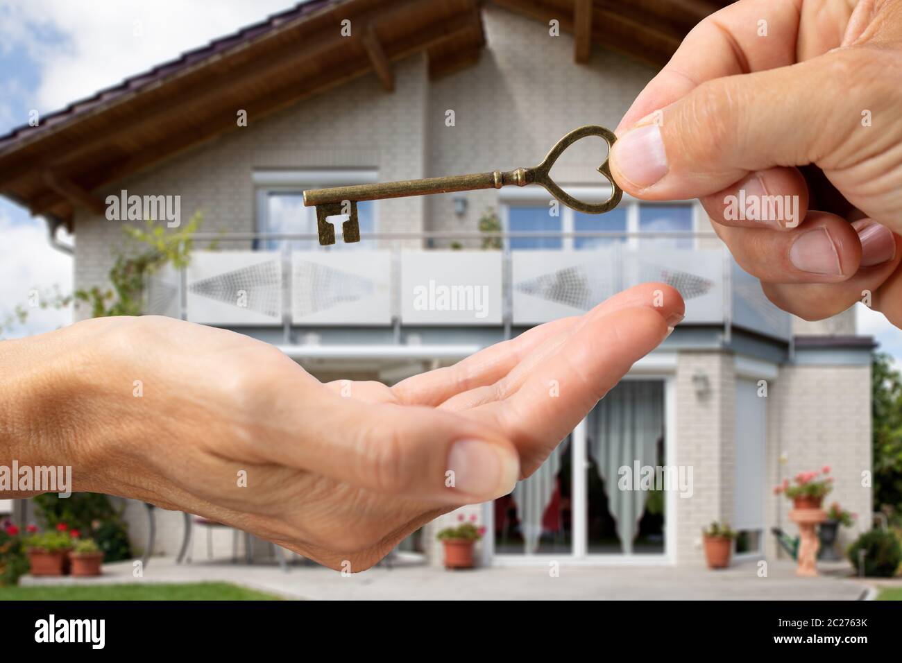 Realtor Hand Giving Home Keys To A Client In Front Of The House Stock ...
