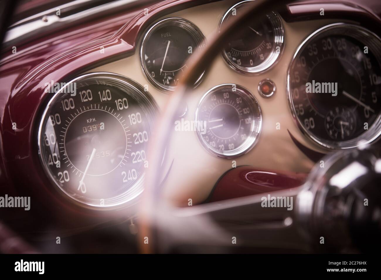 Color close up shot of a tachometer, a clock and other various gauges