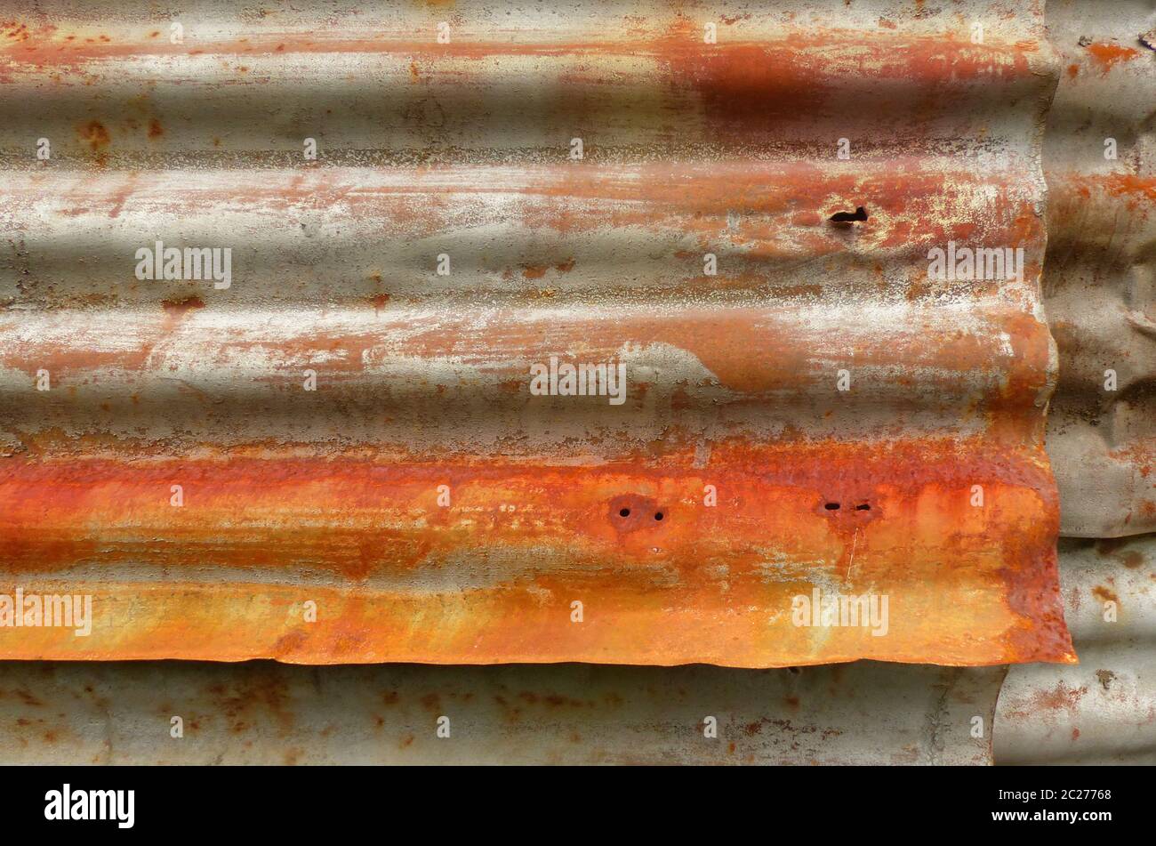 Rust on old corrugated metal sheets of a house wall Stock Photo