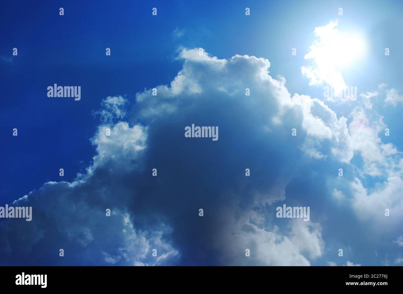 Small bright cloud at the dark cloudy sky Stock Photo