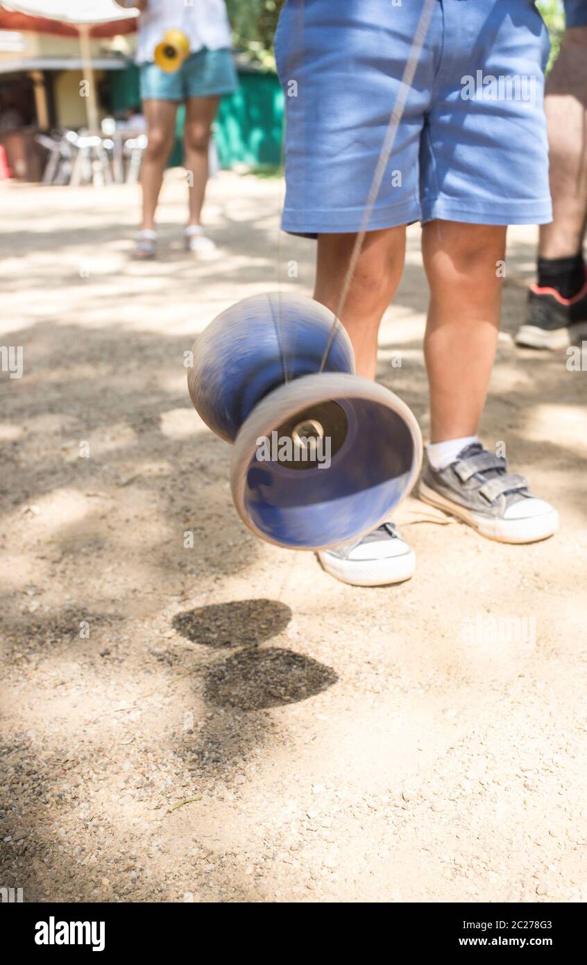 Children learning to use diabolo in the park. Classic games for children concept Stock Photo