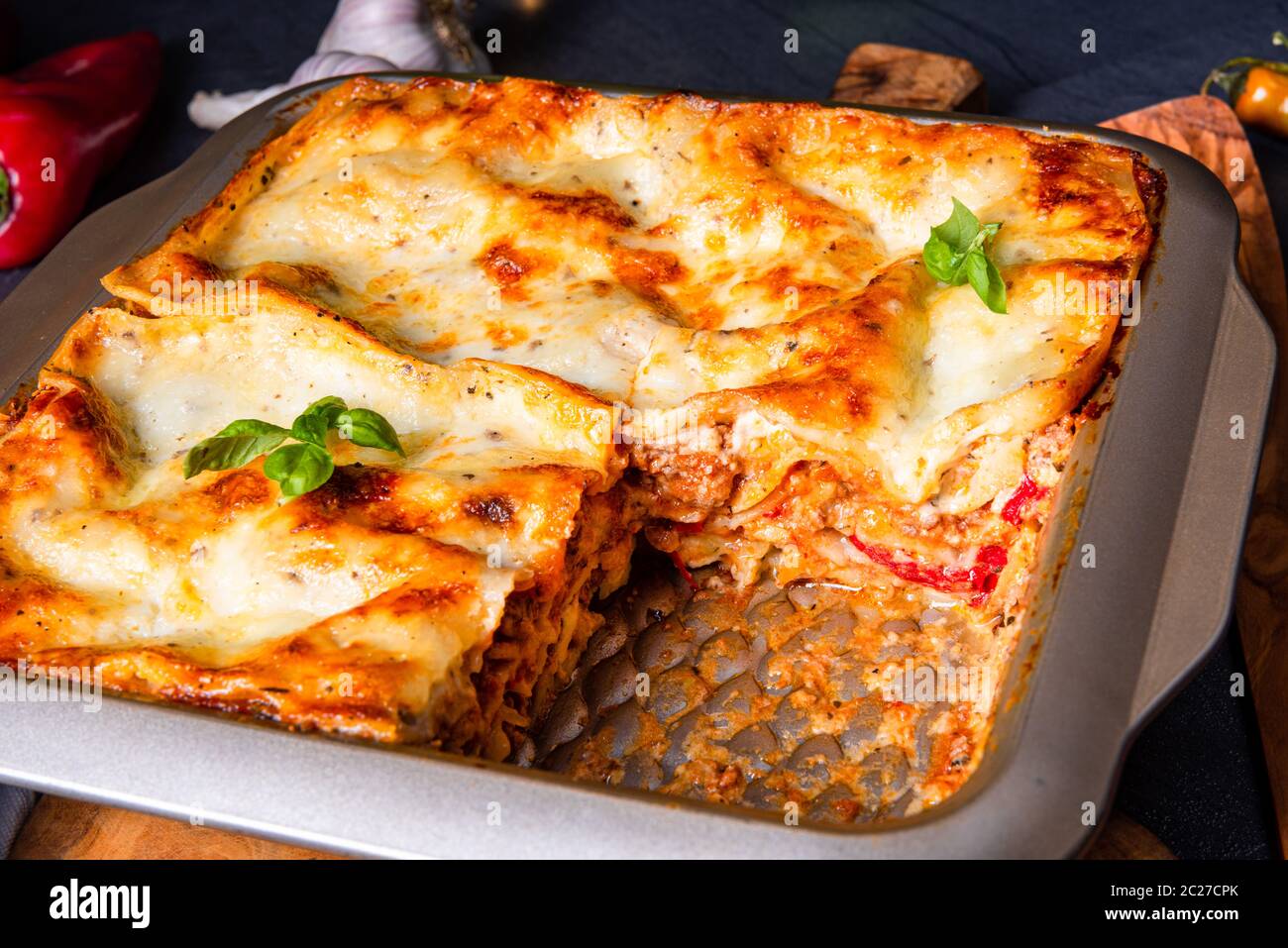 rustic spicy lasagne with basil on the tin Stock Photo Alamy