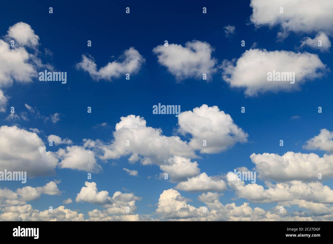 Beautiful blue sky with white fluffy clouds background. Stock Photo