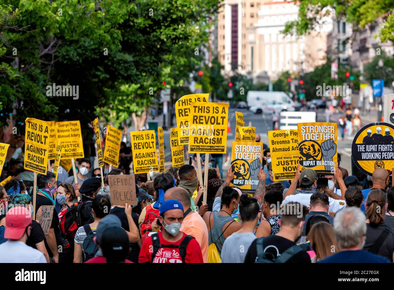 Protesters hold signs against racism and police brutality at anti-racist rally, Black Lives Matter Plaza, Washington, DC, United States Stock Photo