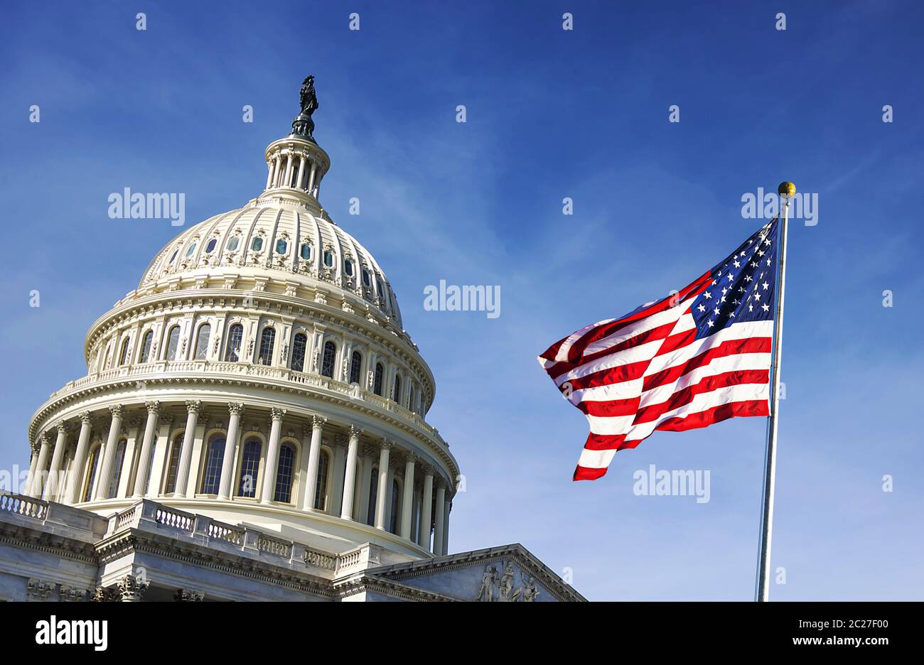 American flag waving with the Capitol Hill Stock Photo - Alamy