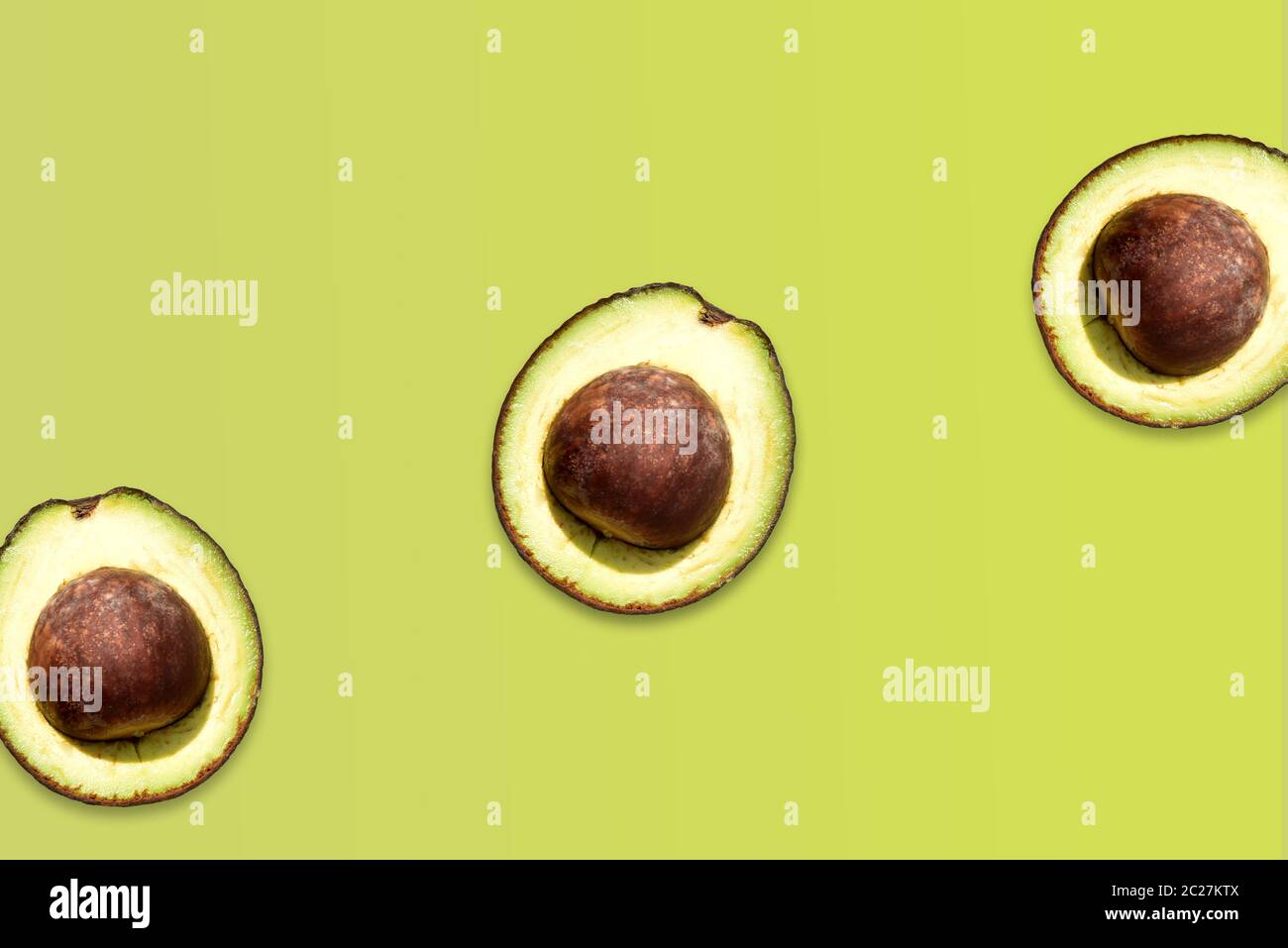 Creative layout made of avocado on the green background. Flat lay. Food ...