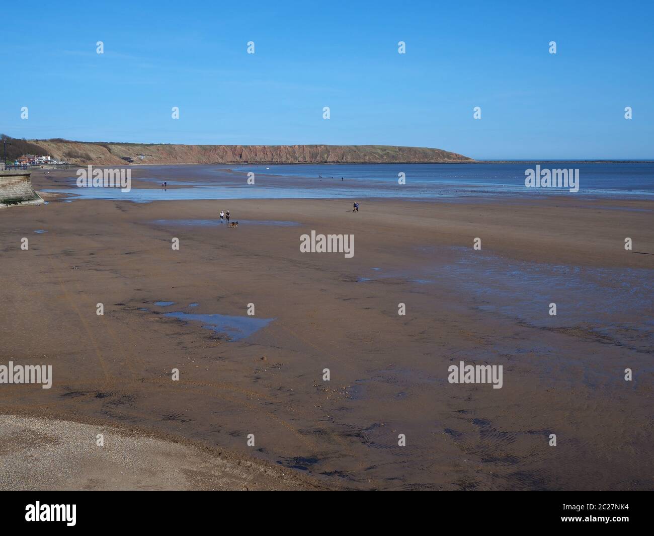 View over the sandy beach at Filey, North Yorkshire, England, towards Filey Brigg at low tide Stock Photo