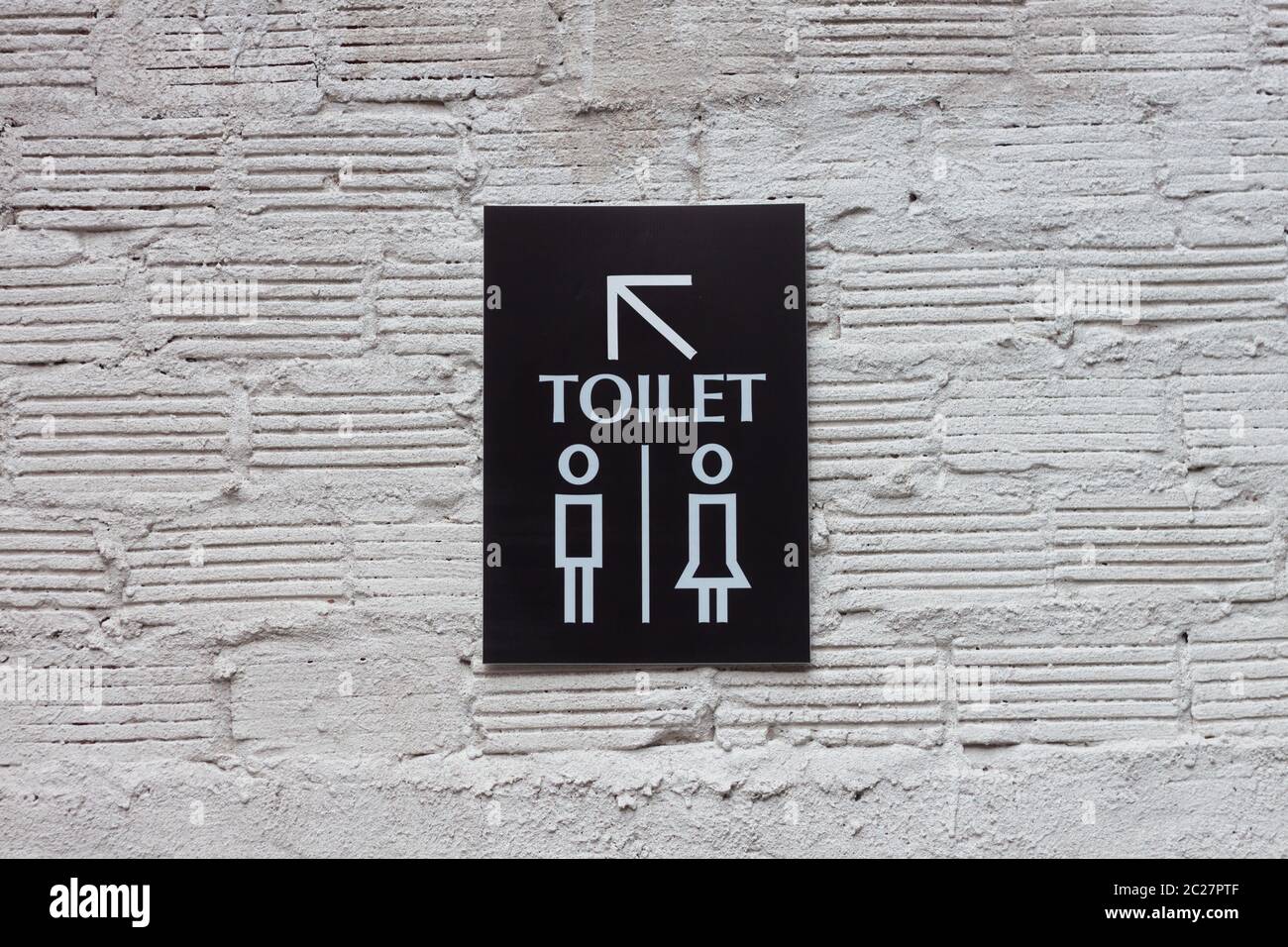 Toilet signs on white wall background, stock photo Stock Photo - Alamy
