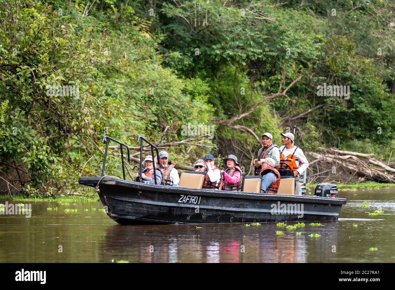 A small boat from the Expeditionary Cruise Ship Zafiro cruises the Amazon in search of wildlife Stock Photo