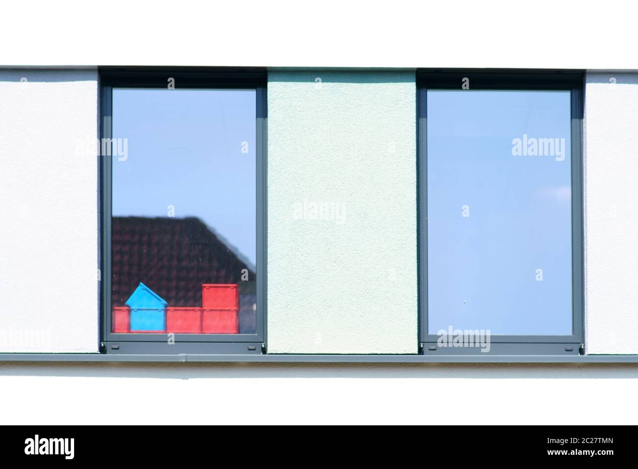 Plastic containers stand behind a window of a business building. Stock Photo
