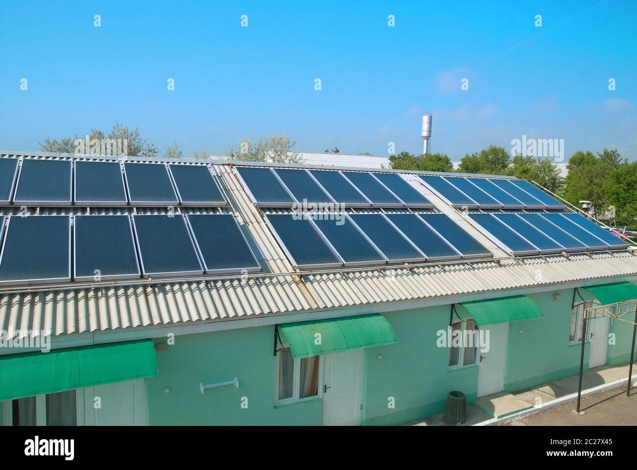 Solar water heating system on the red roof. Gelio panels. Stock Photo