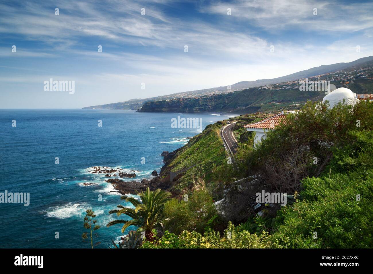 Coastline of the Atlantic ocean with mountains and road view in Puerto de la Cruz, one of the popular resort in the northern part of Tenerife island, Stock Photo