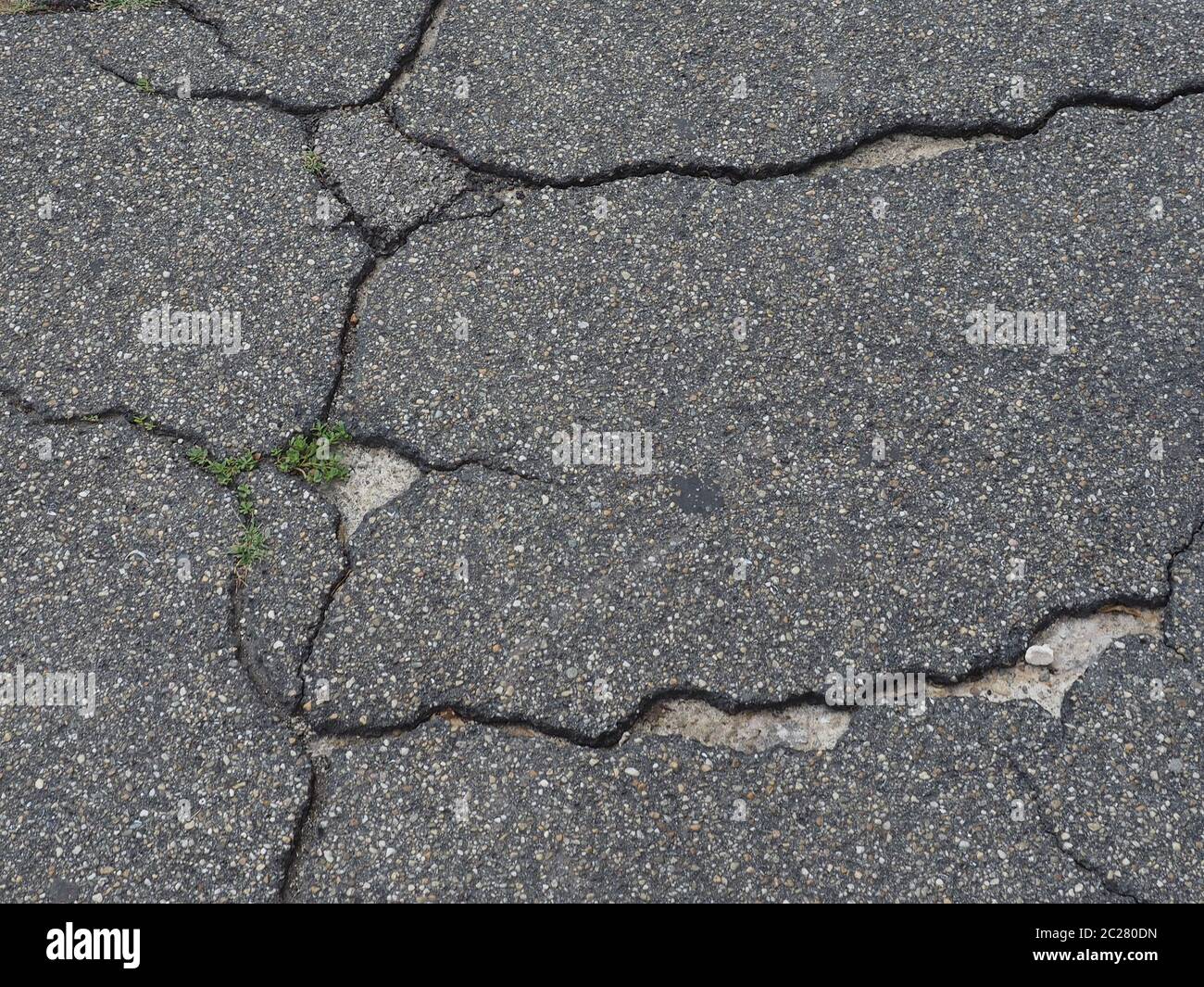 cracked black tarmac texture useful as a background Stock Photo