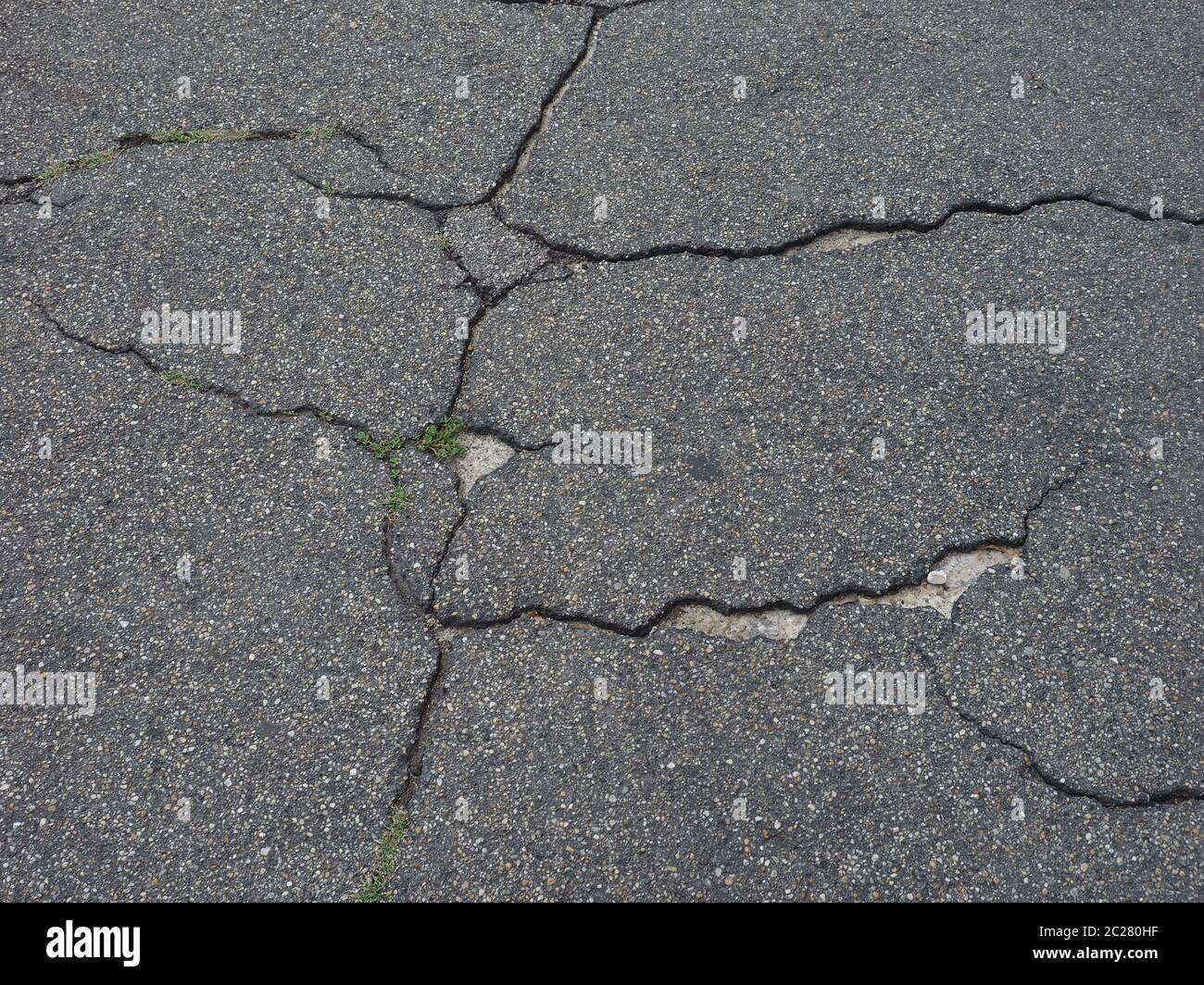cracked black tarmac texture useful as a background Stock Photo
