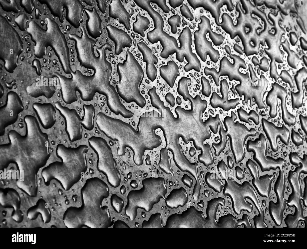 water from rain on a steel surface making an abstract background pattern Stock Photo