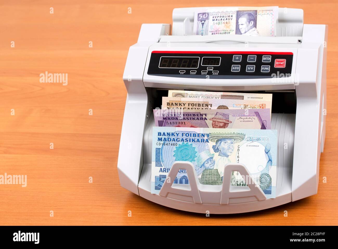 Old money from Madagascar in a counting machine Stock Photo