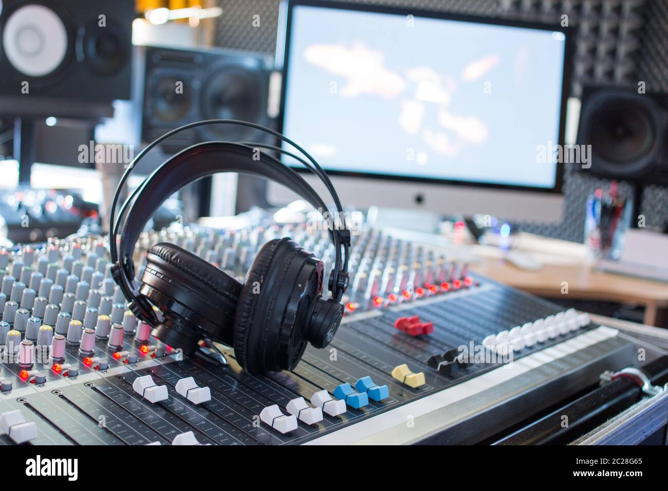 Radio station: Headphones on a mixer desk in an professional sound  recording studio Stock Photo - Alamy