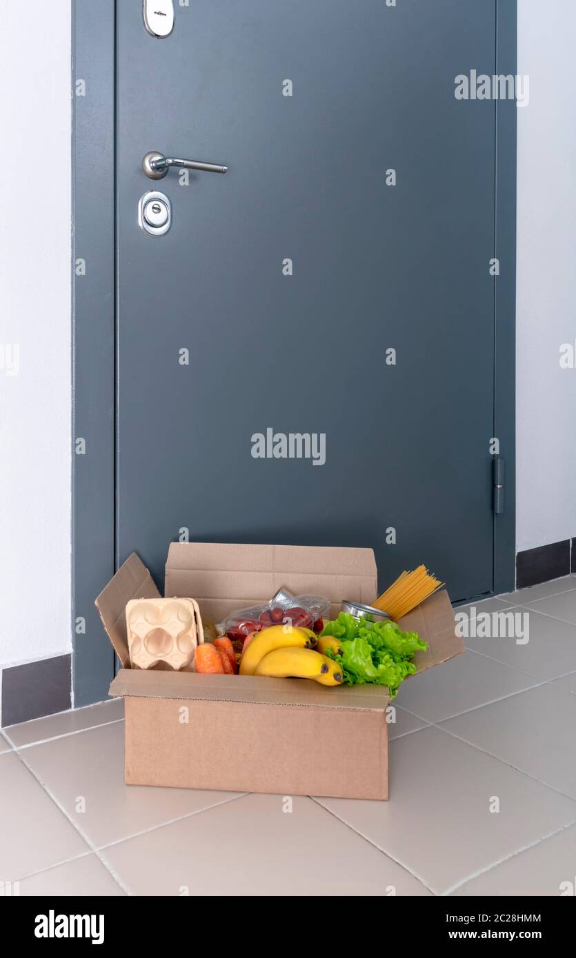 A box of food at the door. Home delivery food. Help to neighbors