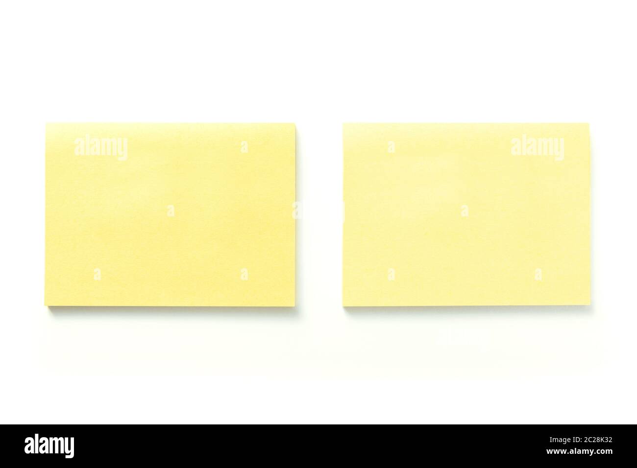 Two blank yellow sticky notes with shadow isolated on white background Stock Photo