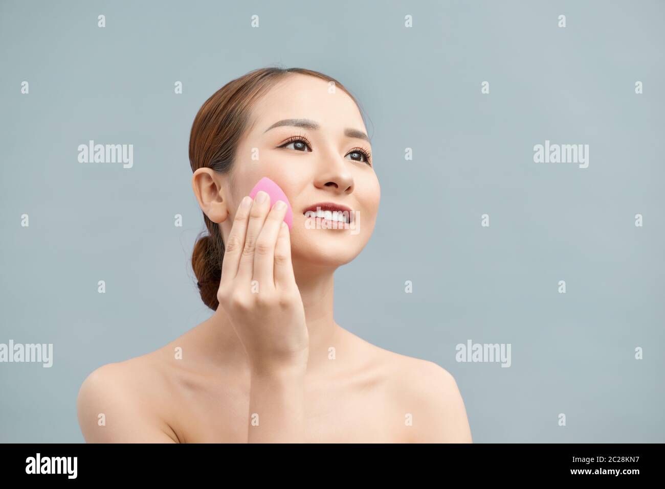young beautiful woman applying her make-up Stock Photo