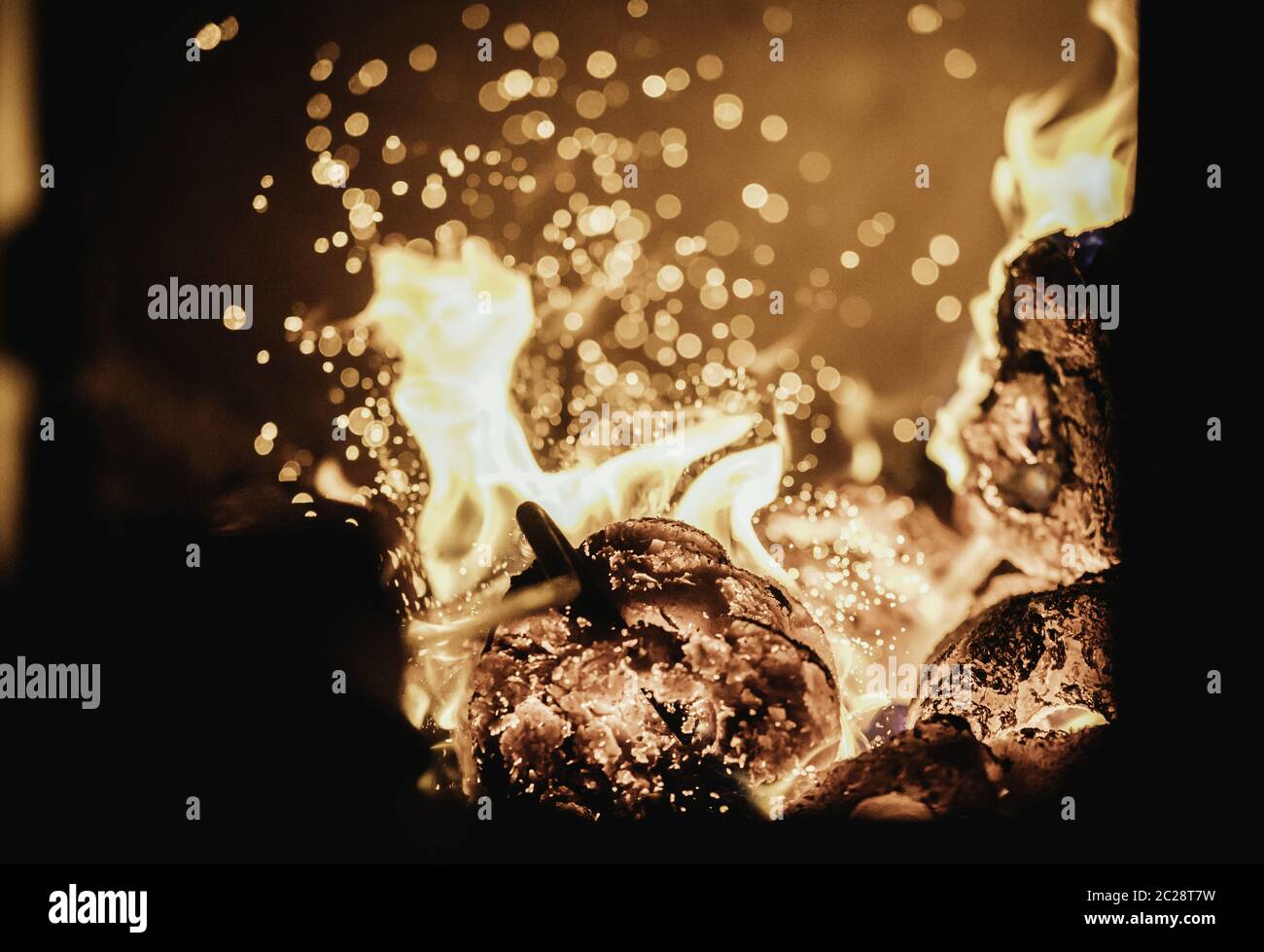 Blaze fire flame in oven, poking stick and sparks Stock Photo - Alamy