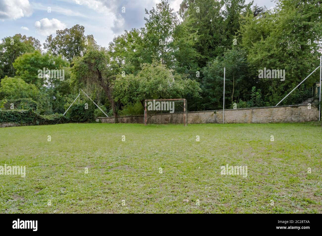 mini-football field on a lawn with a goal a little rusty in front of a wall in the region of Virton in Belgium Stock Photo