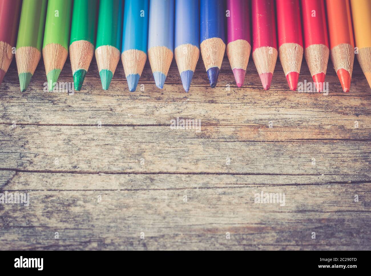 Creativity: Multi-colored pencils on rustic wooden table Stock Photo