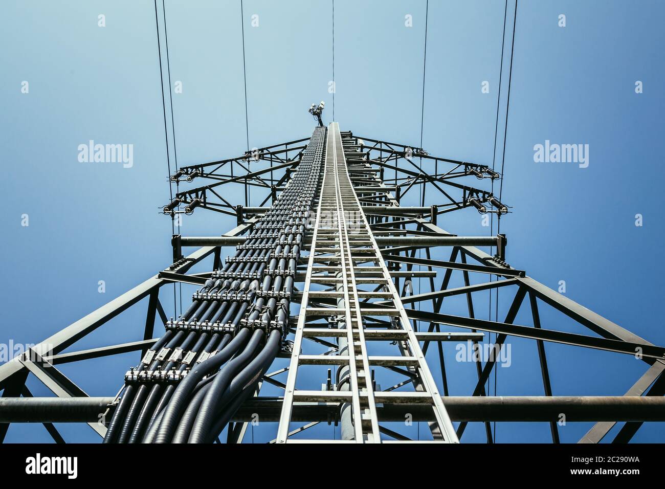 Close up of electrical tower and blue sky. Renewable energy and smart grid. Stock Photo