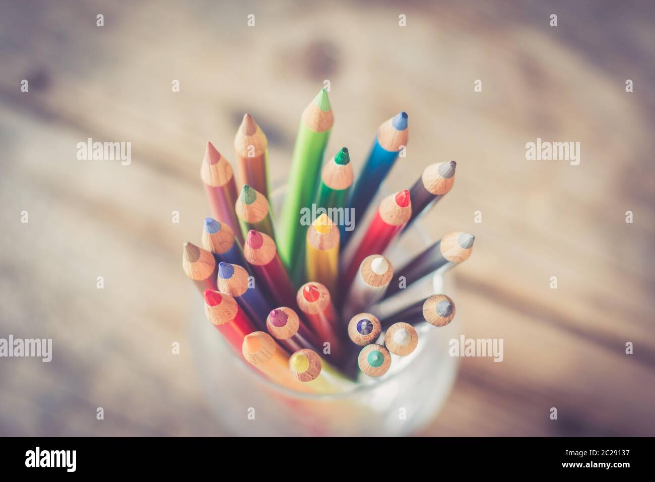 Creativity: Colored pencils in a can on rustic wooden table Stock Photo