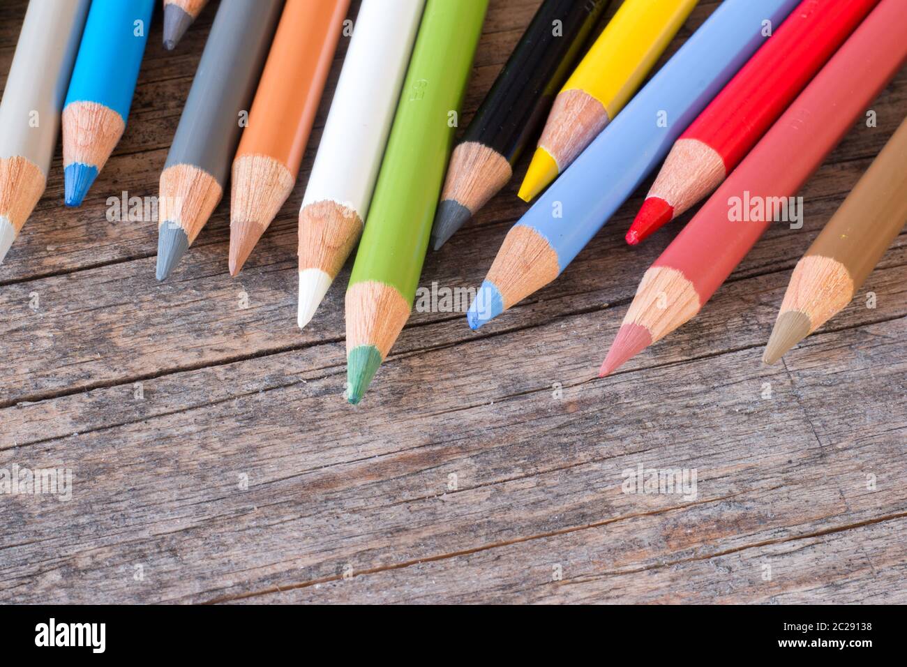 Creativity: Multi-colored pencils on rustic wooden table Stock Photo