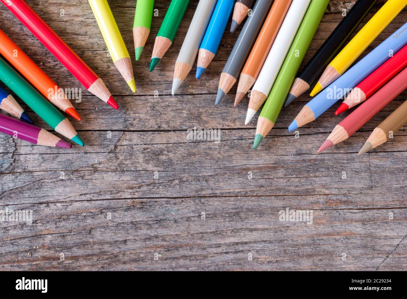 Creativity: Multi-colored pencils on rustic wooden table Stock Photo