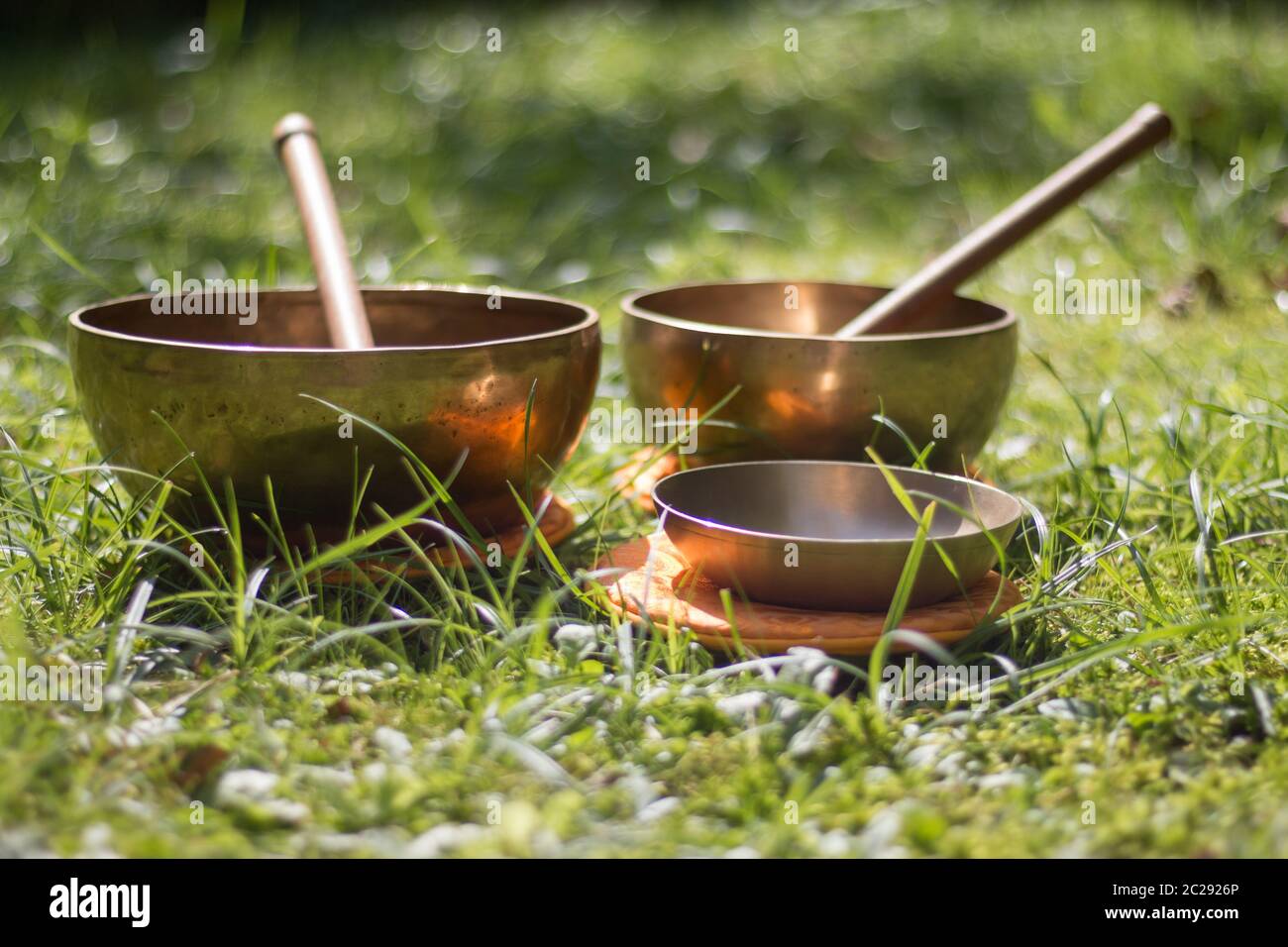 Set of singing bowls in the own garden, zen outdoors Stock Photo Alamy