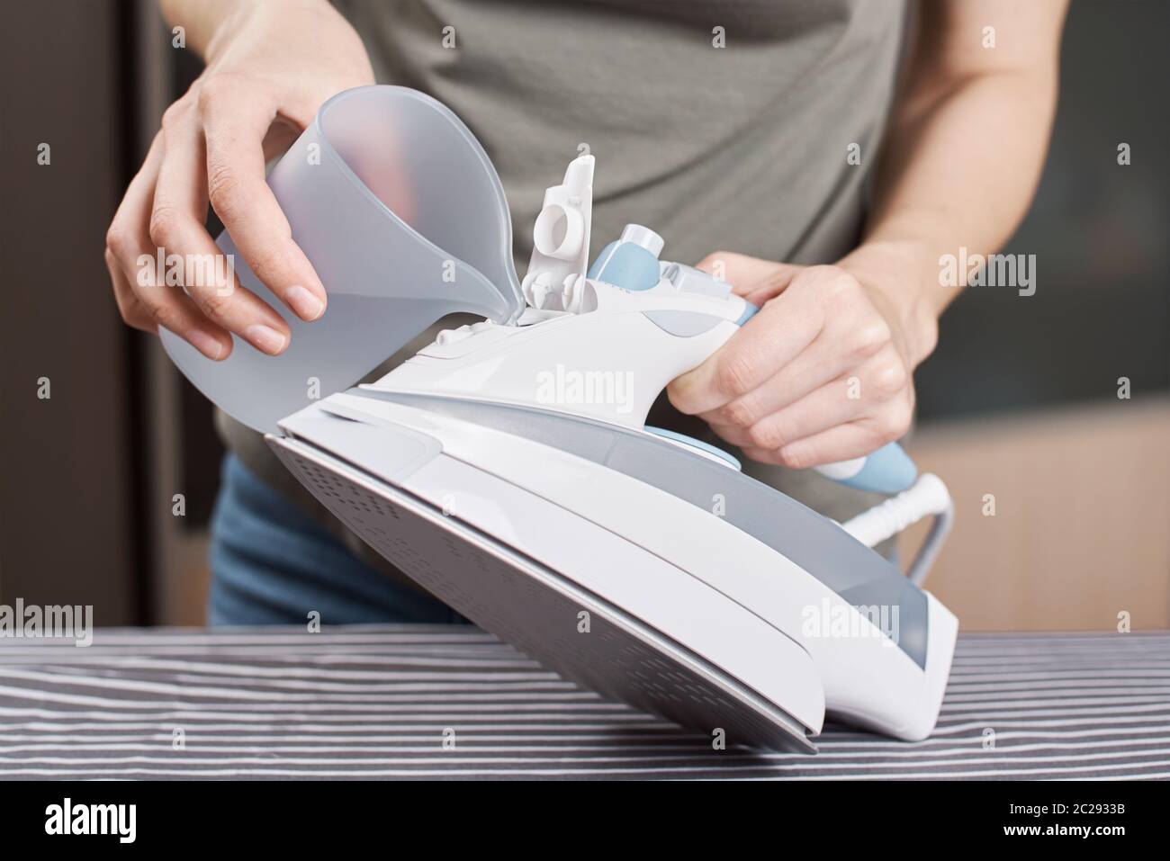 Laundry Services. Woman Hand Ironing Cloth On Ironing Board Stock Photo -  Alamy