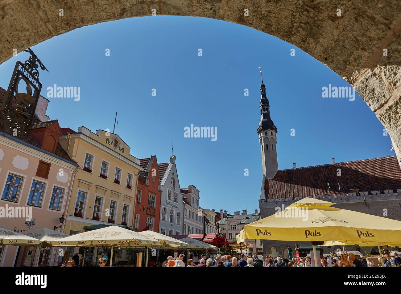 Tourists crowd enjoying shopping at the medieval Town Square in the walled city of Tallinn Estonia. Stock Photo