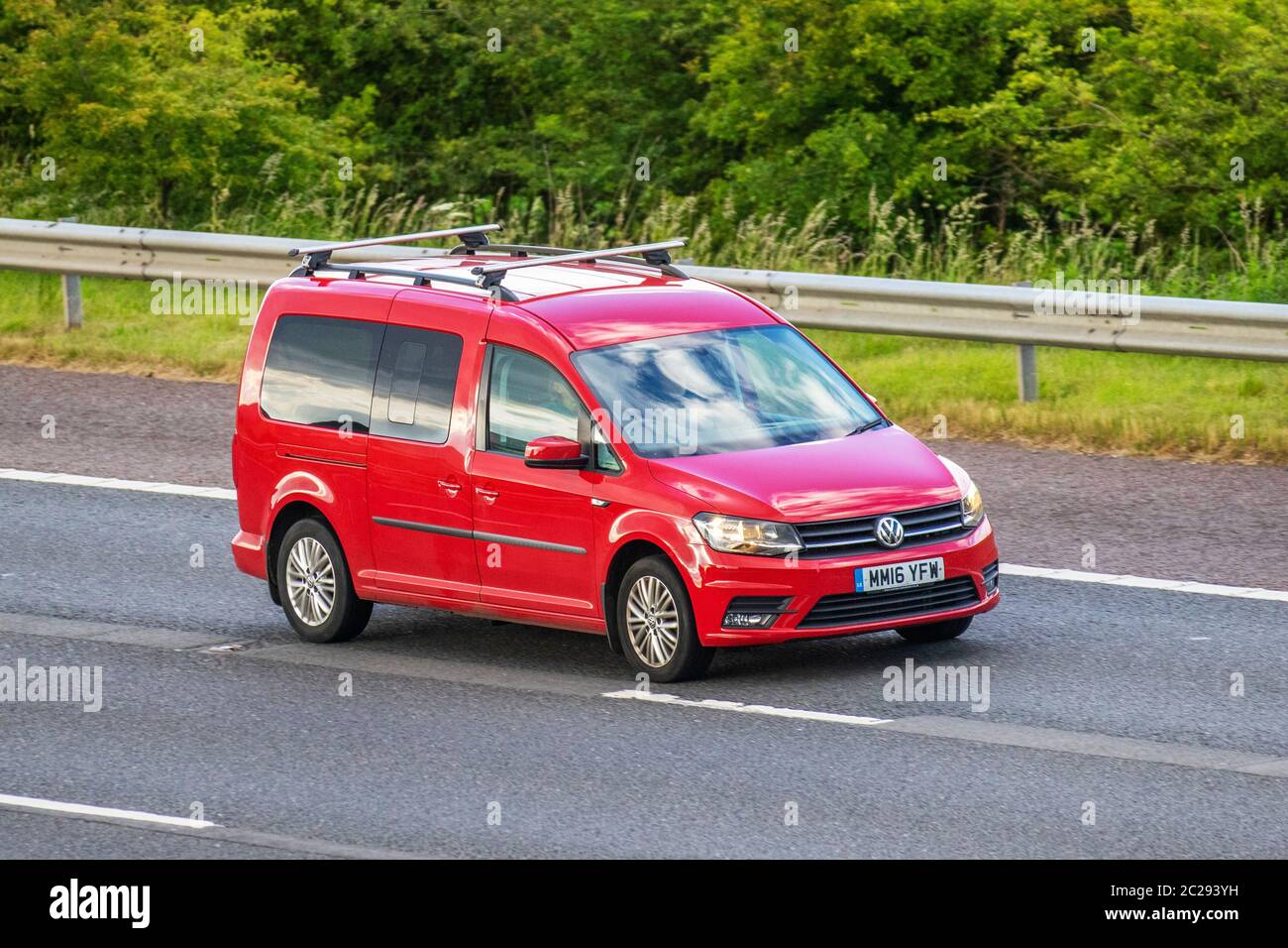 2016 red Volkswagen Caddy Maxi C20 Life TDI; Vehicular traffic moving vehicles, cars driving vehicle on UK roads, motors, motoring on the M6 motorway Stock Photo