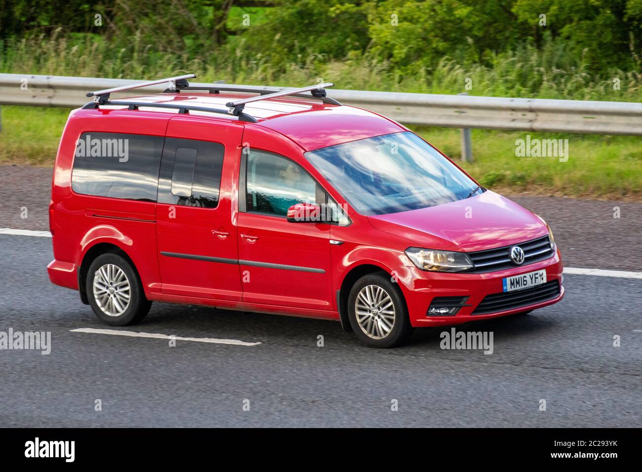 2016 red VW Volkswagen Caddy Maxi C20 Life TDI; Vehicular traffic moving vehicles, cars driving vehicle on UK roads, motors, motoring on the M6 motorway Stock Photo