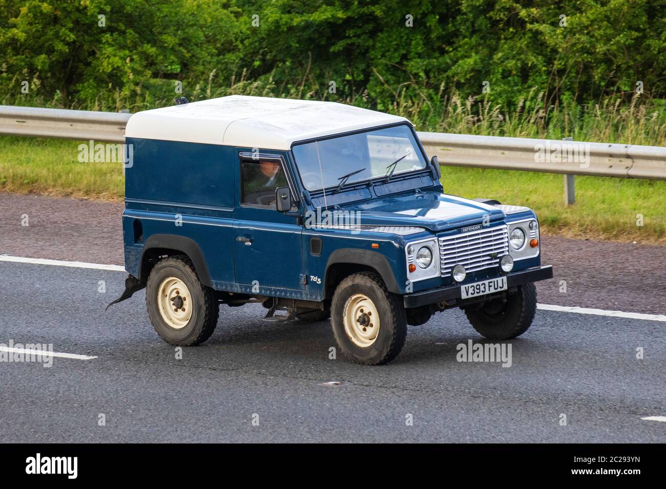 1999 blue Land Rover Defender 90 TD5; Vehicular traffic moving vehicles,  cars driving vehicle on UK roads, motors, motoring on the M6 motorway Stock  Photo - Alamy