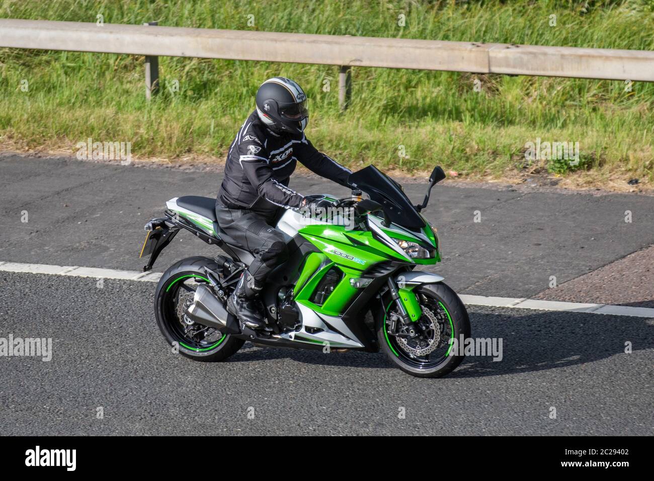 Green KAWASAKI Z1000SX; Motorbike rider; two wheeled transport, motorcycles, vehicle, roads, motorbikes, bike riders motoring in Chorley, UK Stock Photo