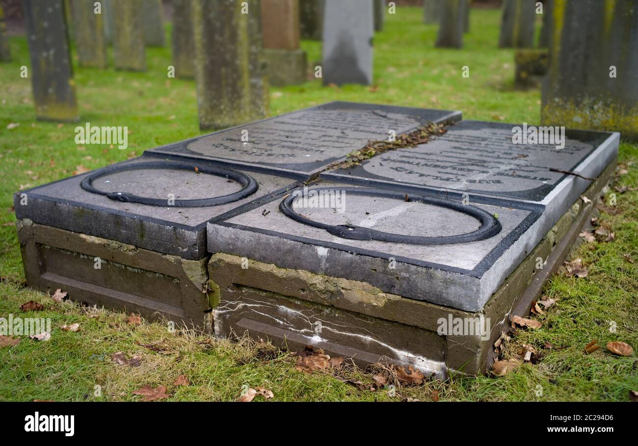 Lying decorated old tombstones of a married couple on a cemetery in autumn. True love Stock Photo